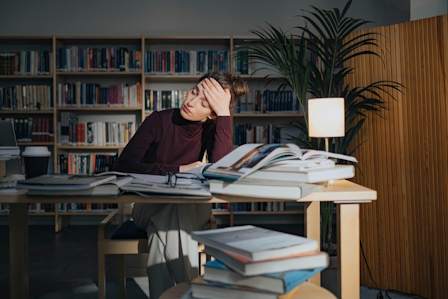Person looking visibly tired at their desk or on a couch